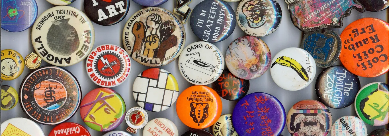 Collection of buttons in varying sizes and sentiments