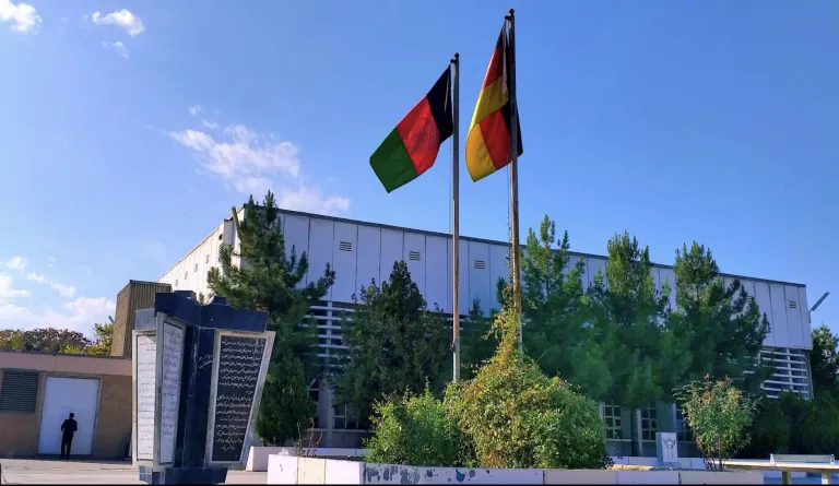 flags of afghanistan and germany outside of a building