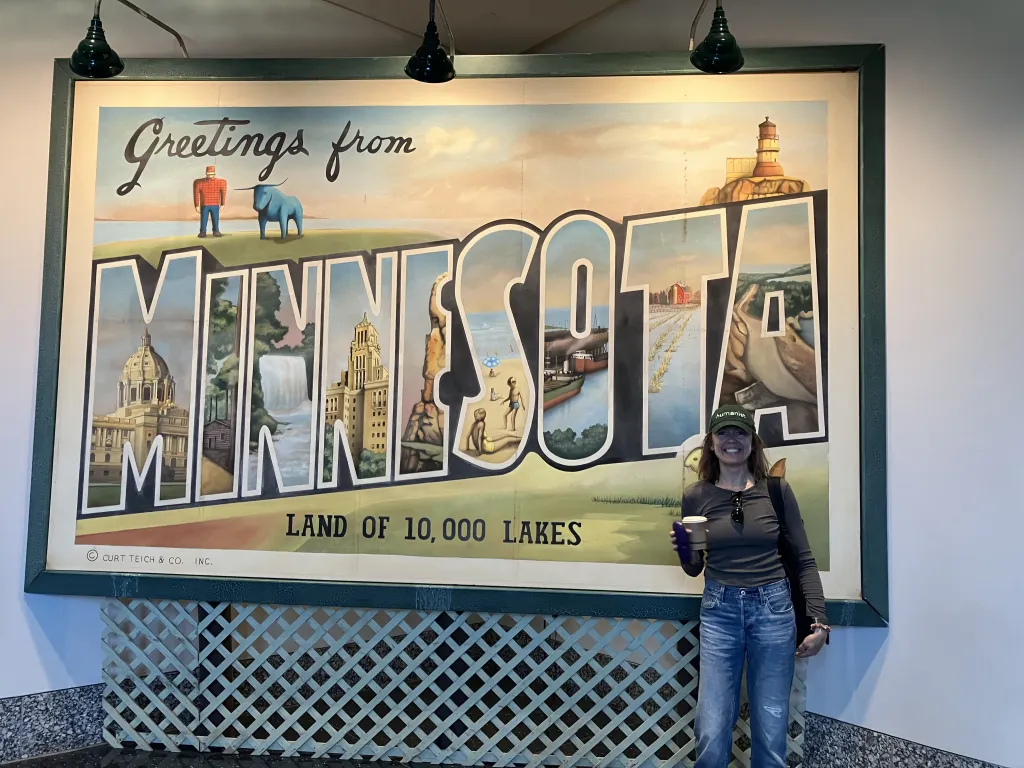 Person in a hat in front of a billboard