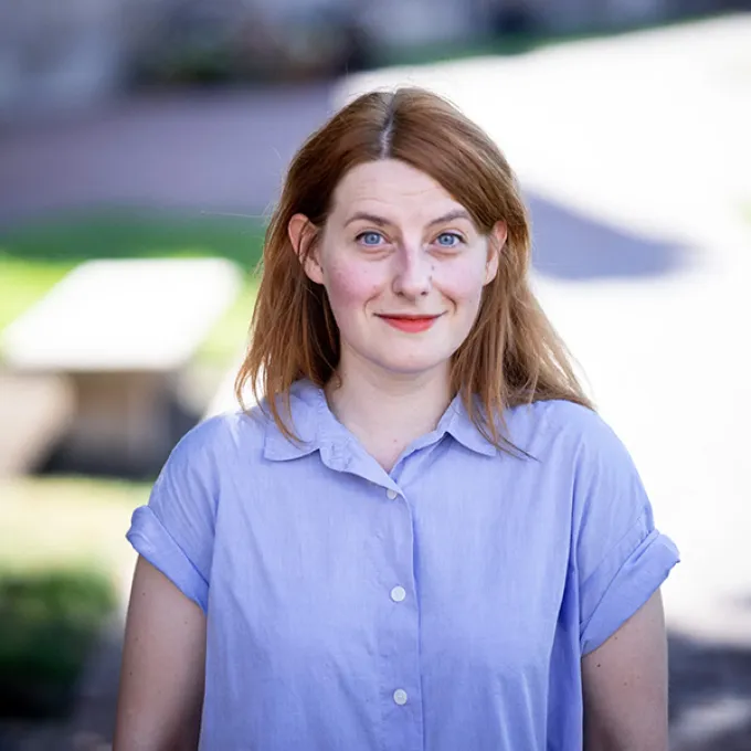 "woman wearing a blue shirt in an outdoor setting"