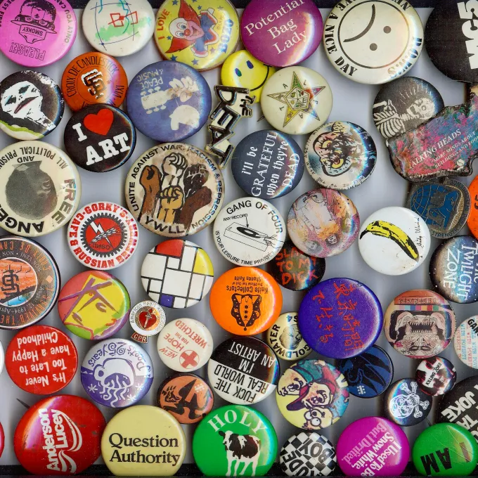 A collection of buttons of varying sizes and sentiments