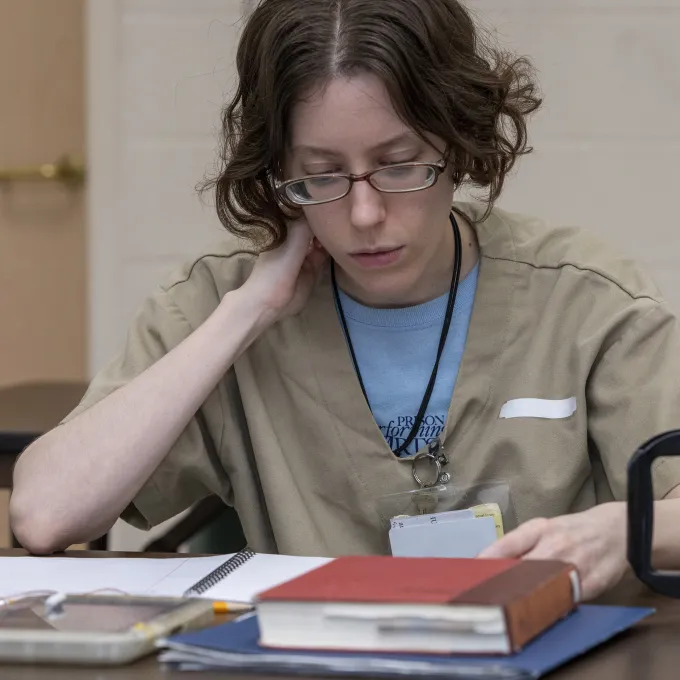 Person reading at a table 